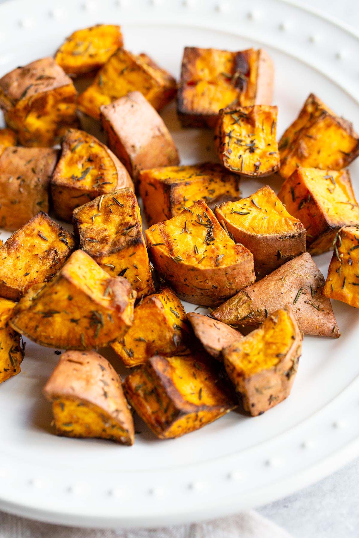 Air fried sweet potatoes on a white plate.