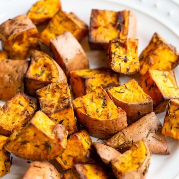 Air fried sweet potatoes on a white plate.