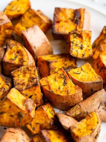 Air fried sweet potatoes on a white plate.