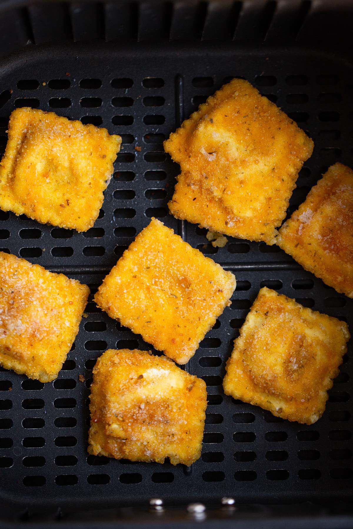 Breaded ravioli in air fryer basket