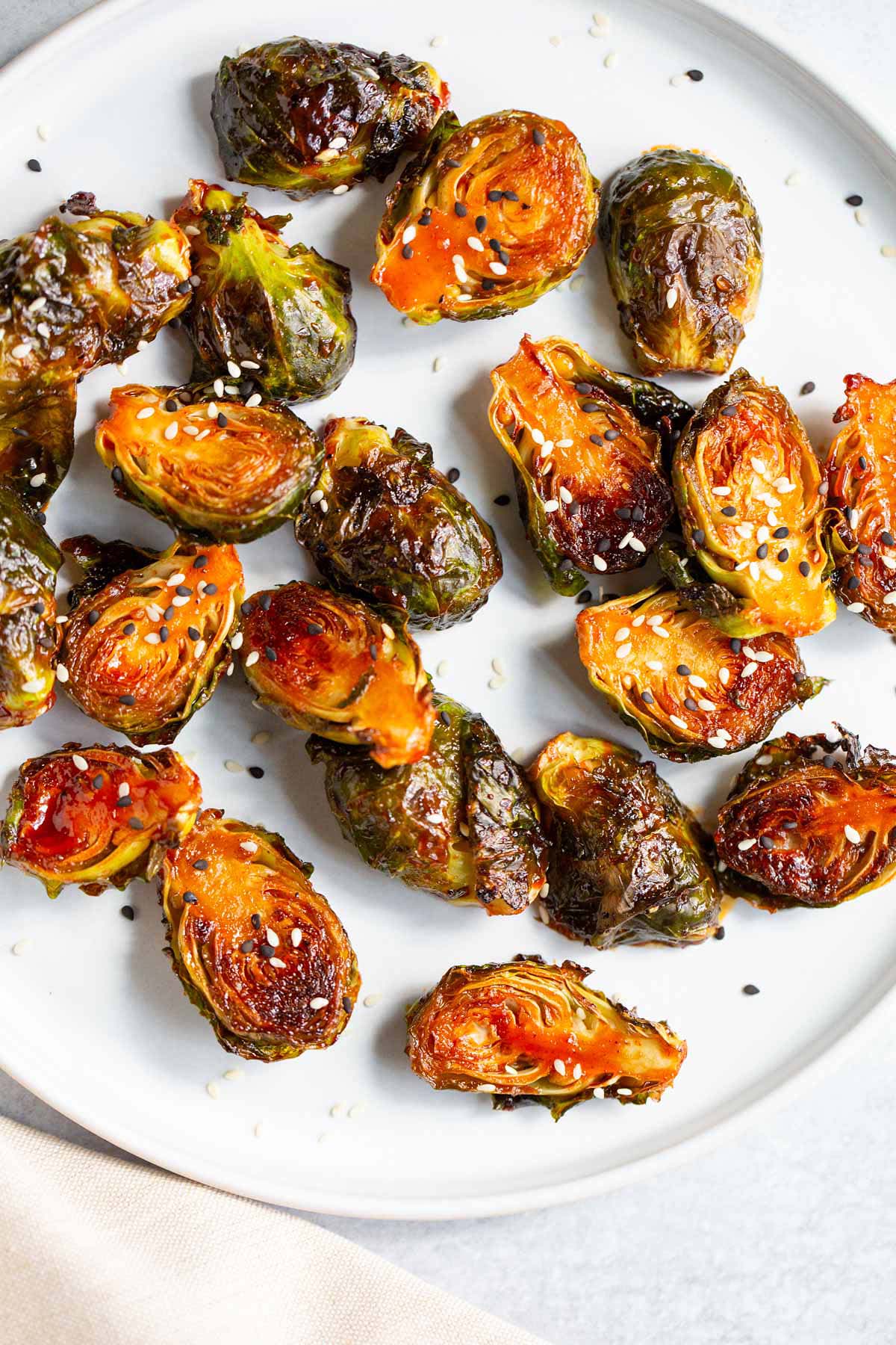 Gochujang brussels sprouts topped with sesame seeds.