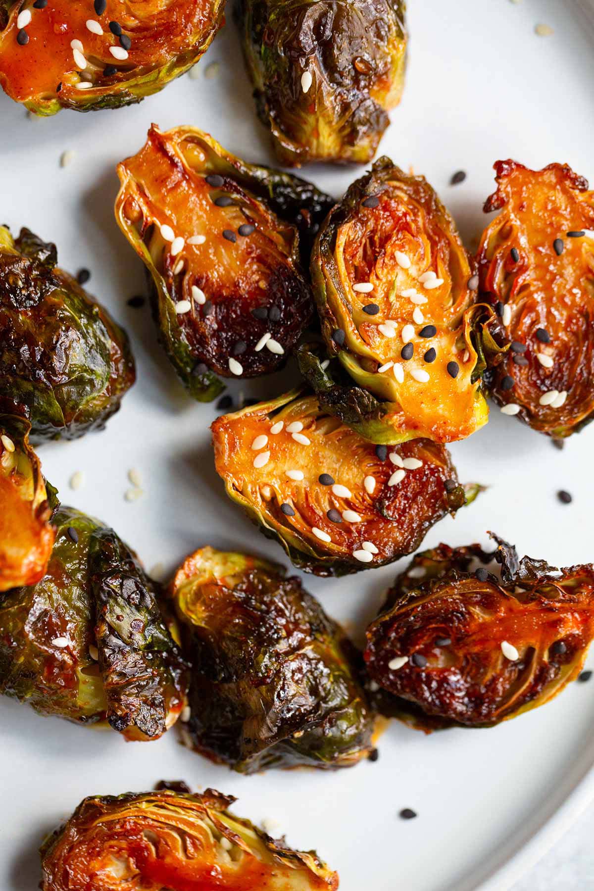 Gochujang brussels sprouts topped with sesame seeds.