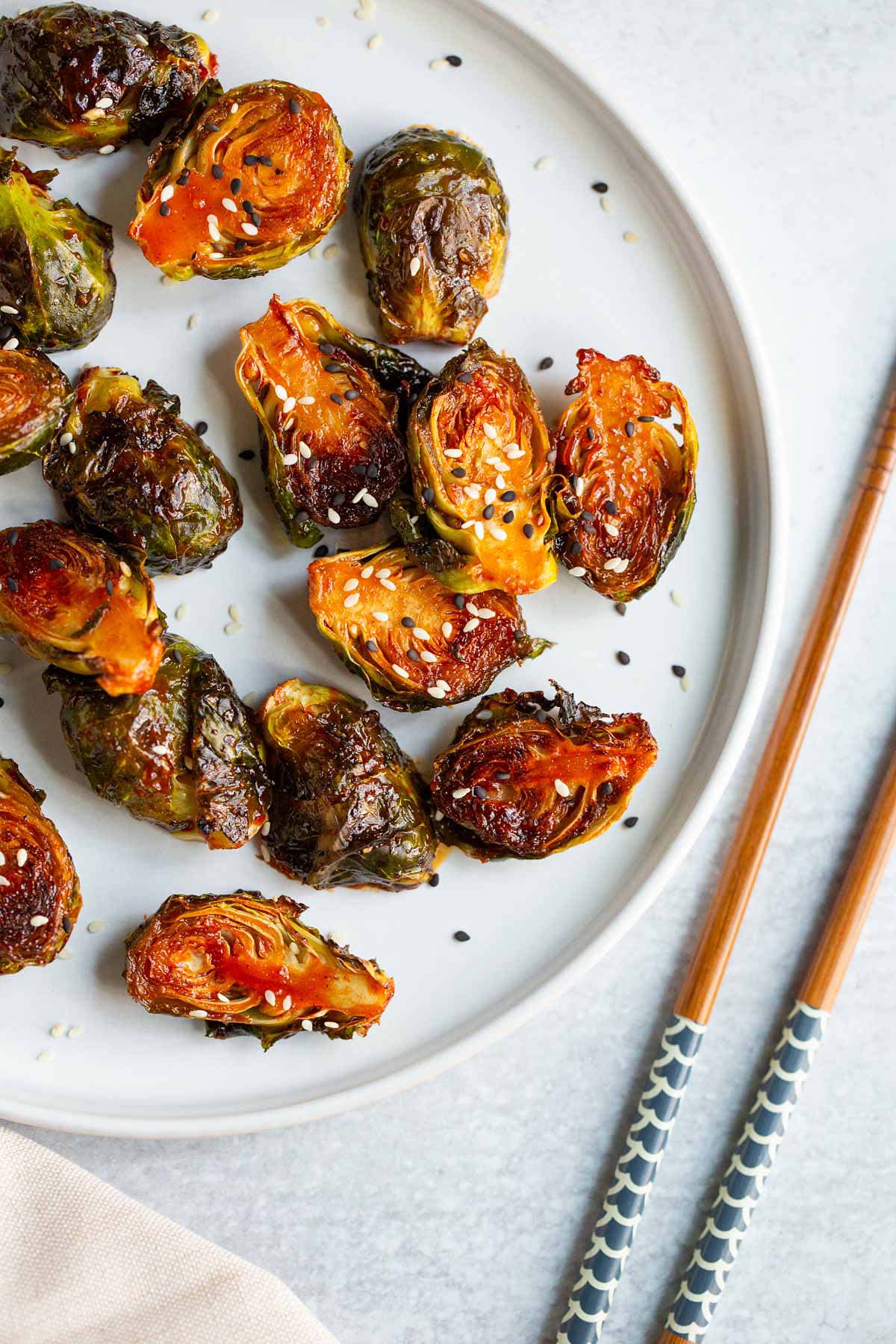 Gochujang brussels sprouts topped with sesame seeds.