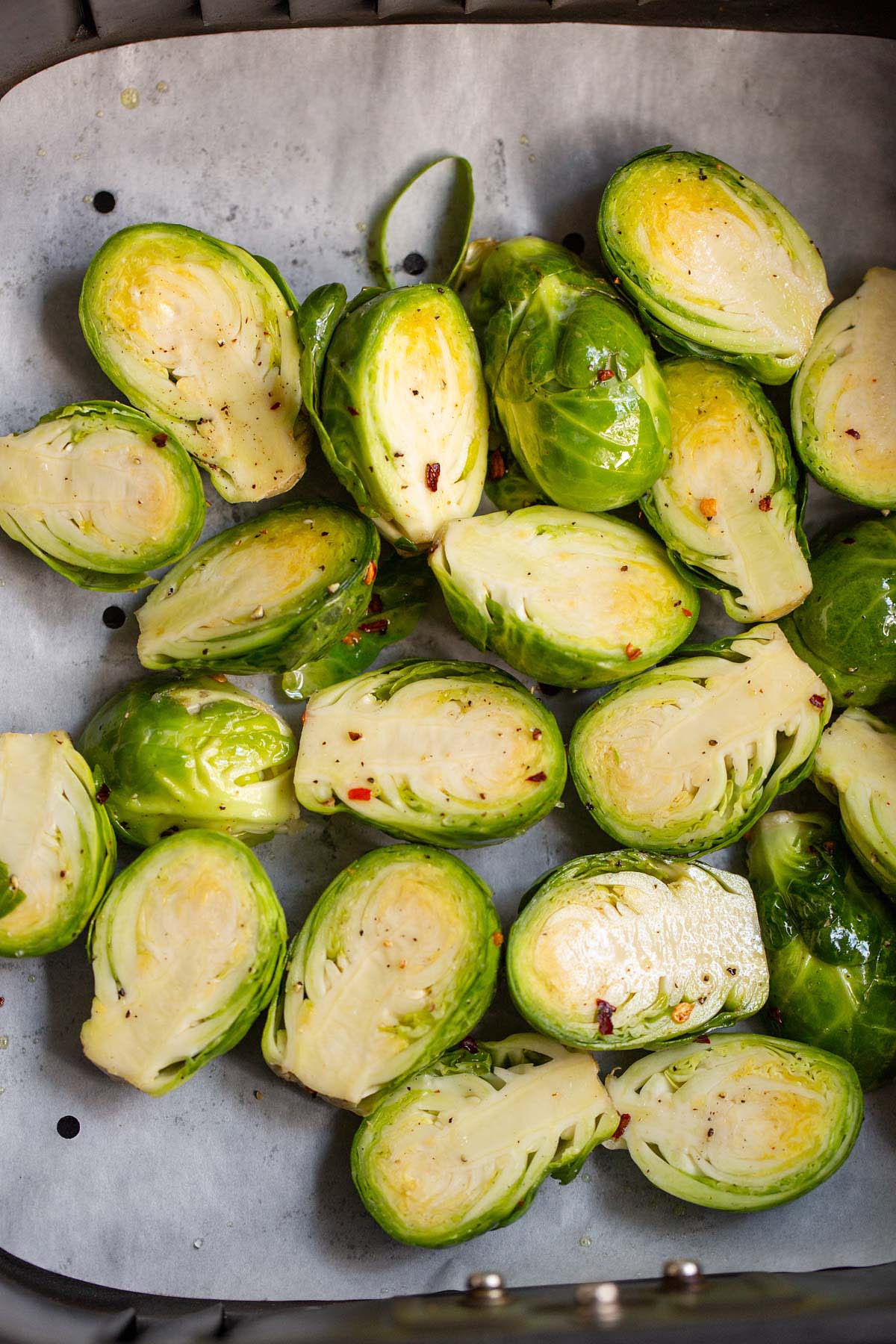 Uncooked brussels sprouts in air fryer.