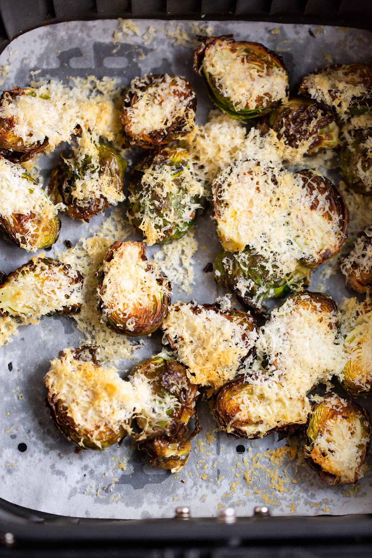 Air fried parmesan brussels sprouts in air fryer basket.