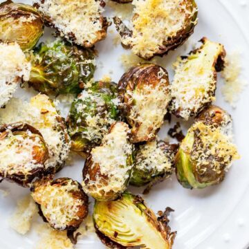 Air fried parmesan brussels sprouts on a white plate.