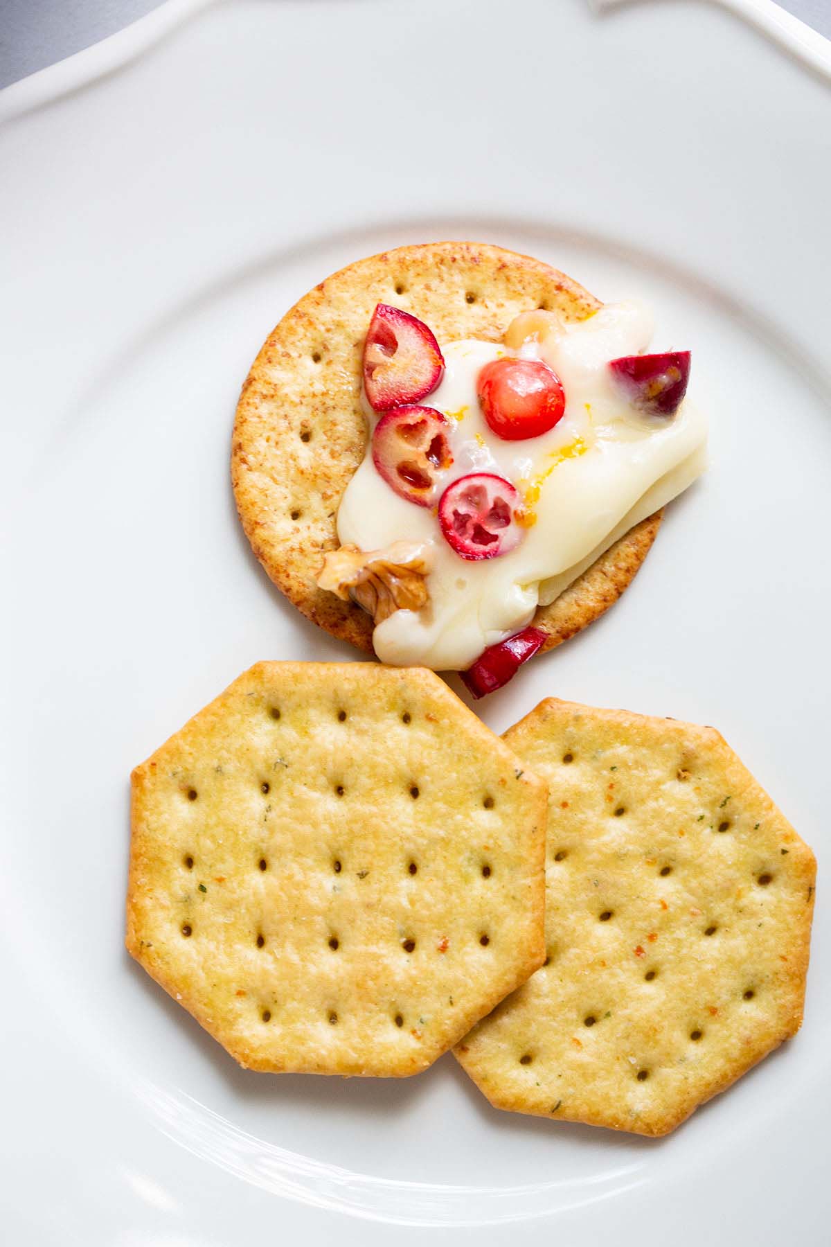 Baked brie spread onto a cracker.