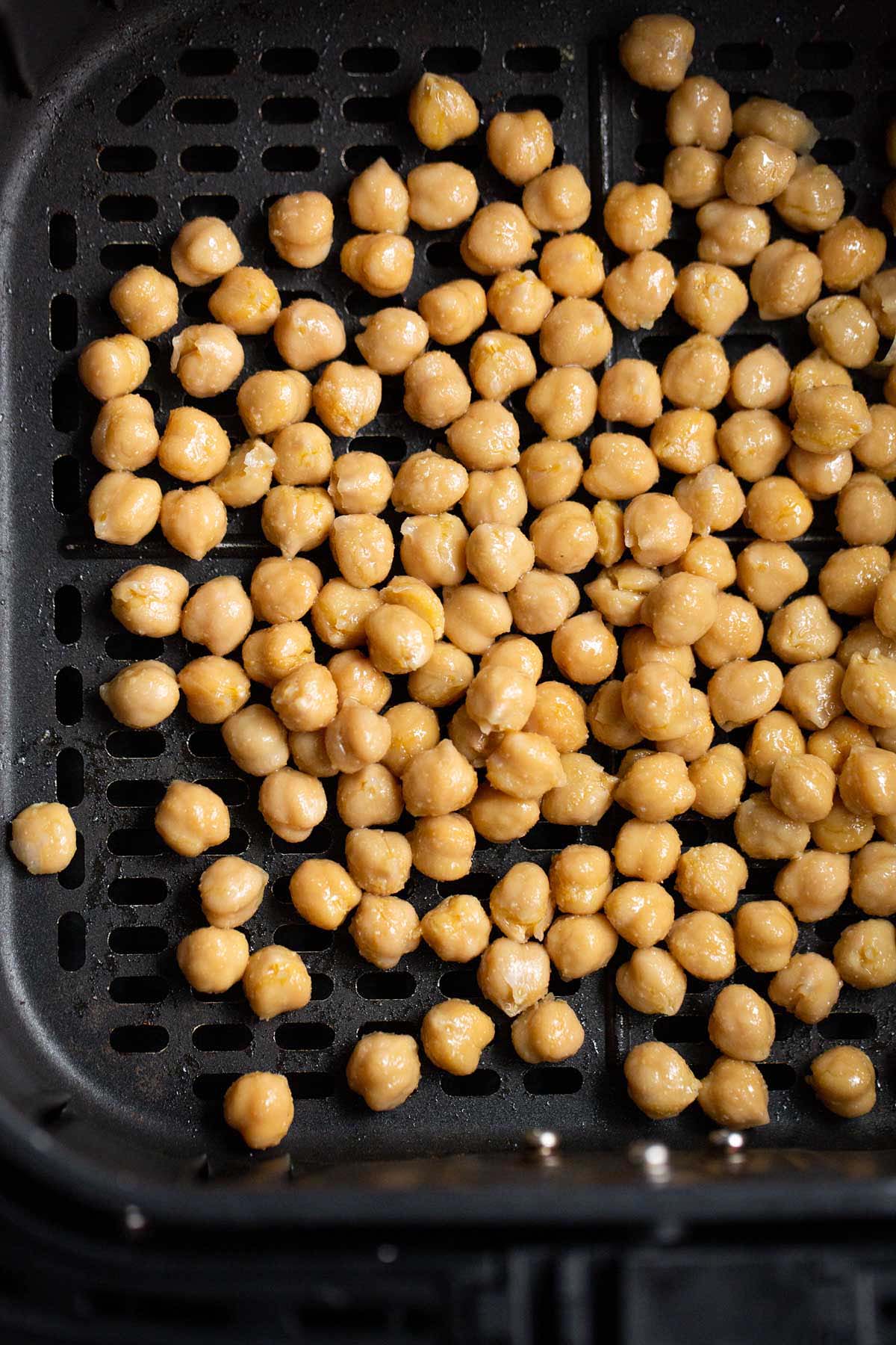 Chickpeas in air fryer basket.