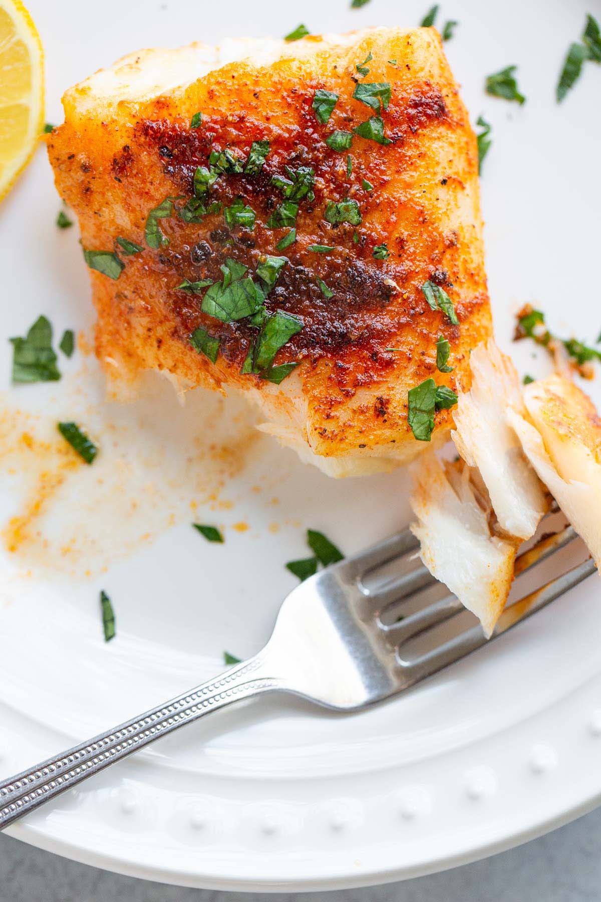 Air fryer cod cut into it with a fork.
