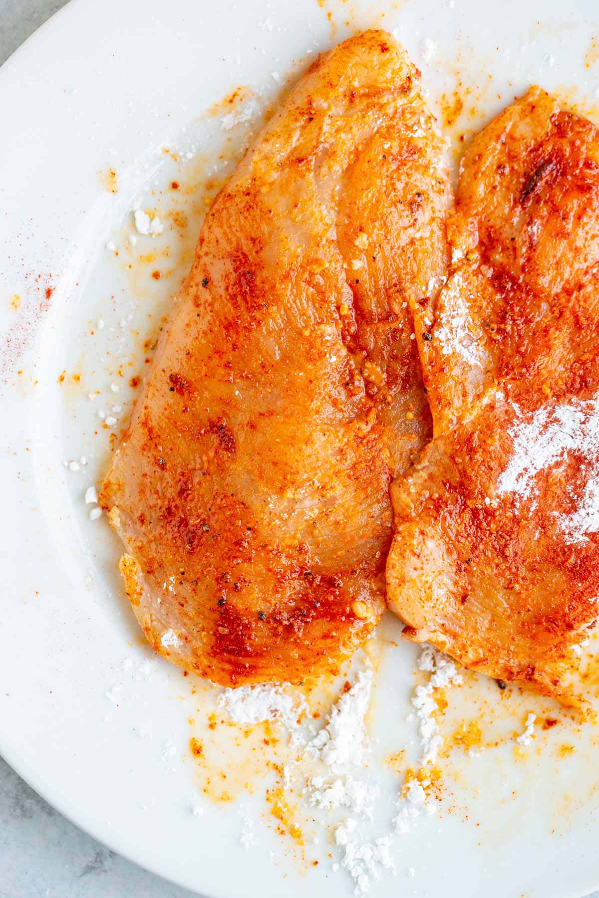 Chicken breasts tossed with cornstarch.