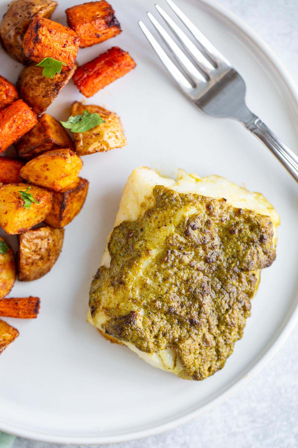 Air fried pesto cod on a plate.