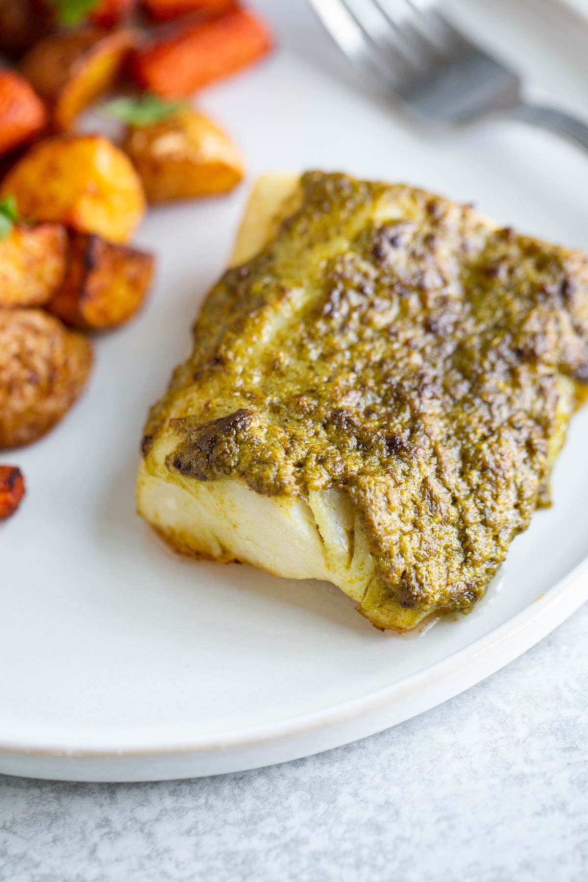 Air fried pesto cod on a plate.