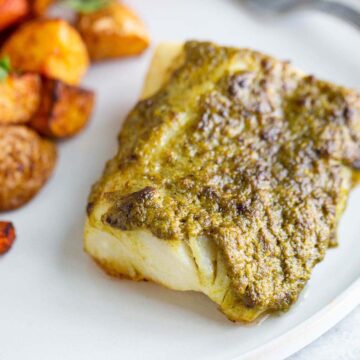 Air fried pesto cod on a plate.