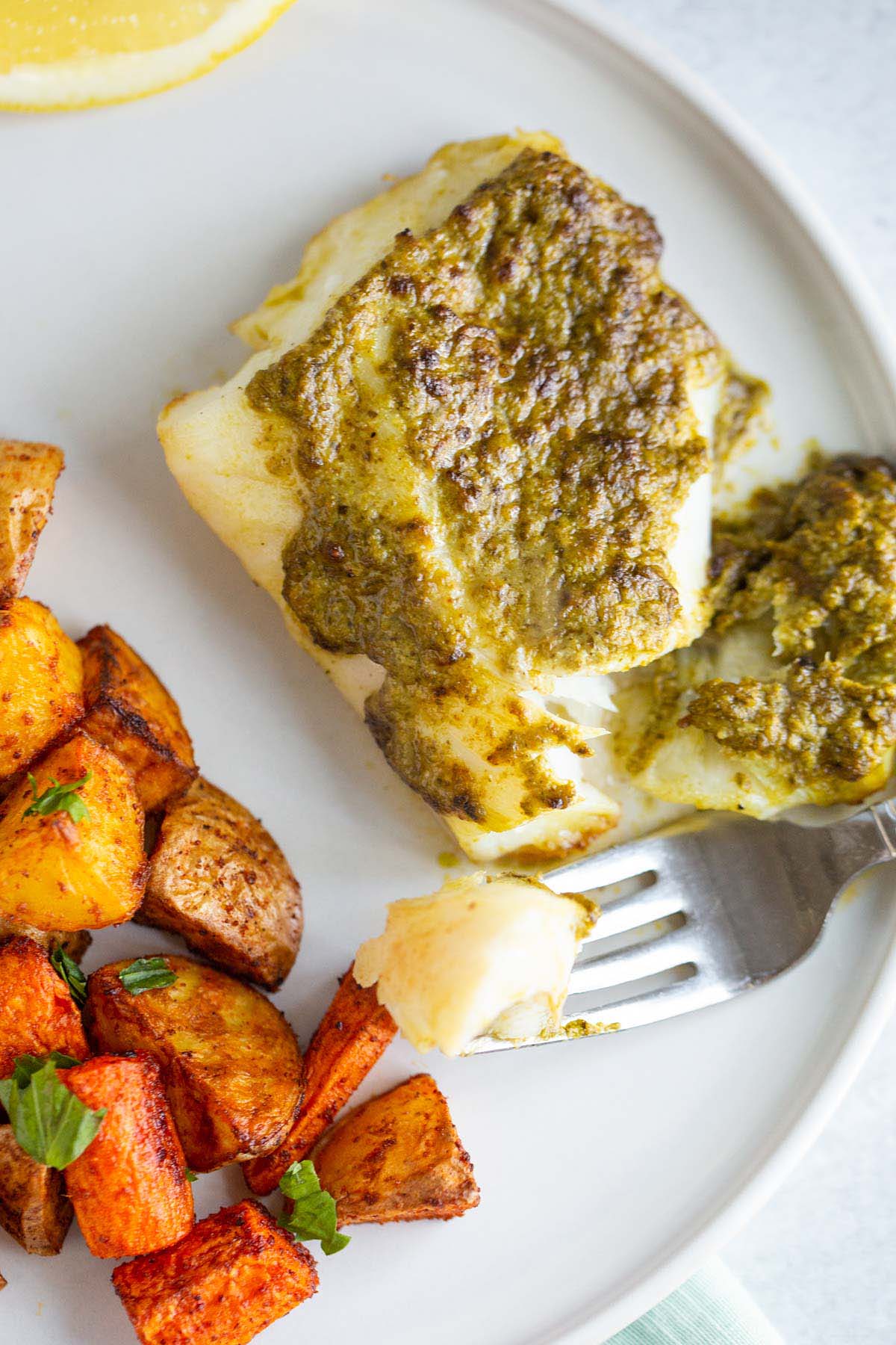 Pesto cod flaked with a fork