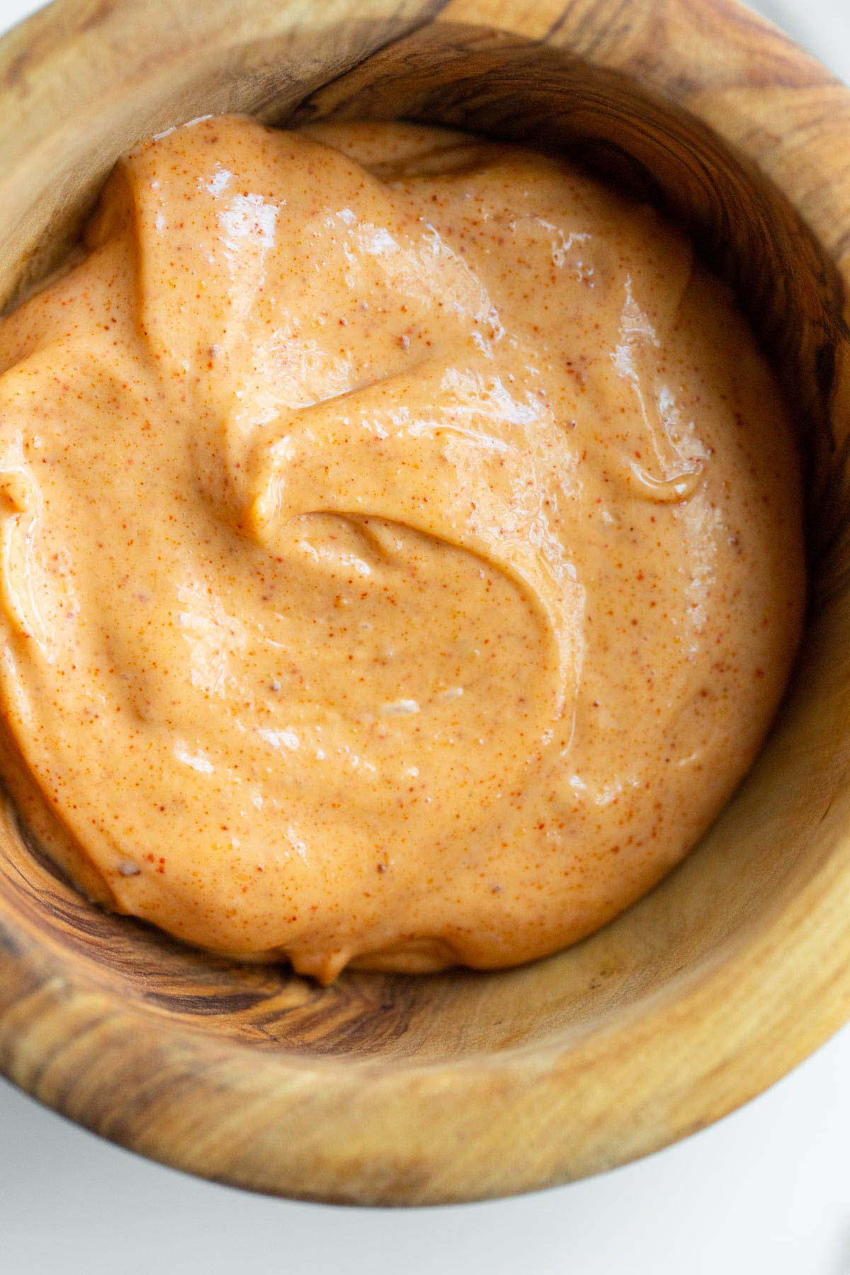 Peri peri mayo in a wooden bowl.