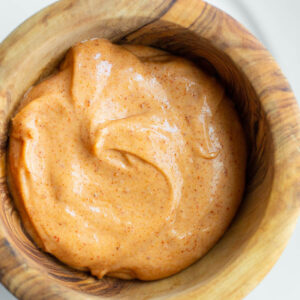 Peri peri mayo in a wooden bowl.