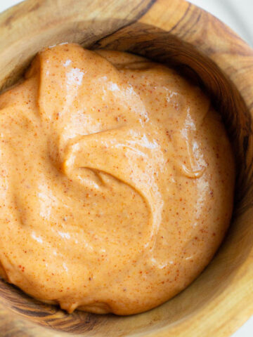 Peri peri mayo in a wooden bowl.