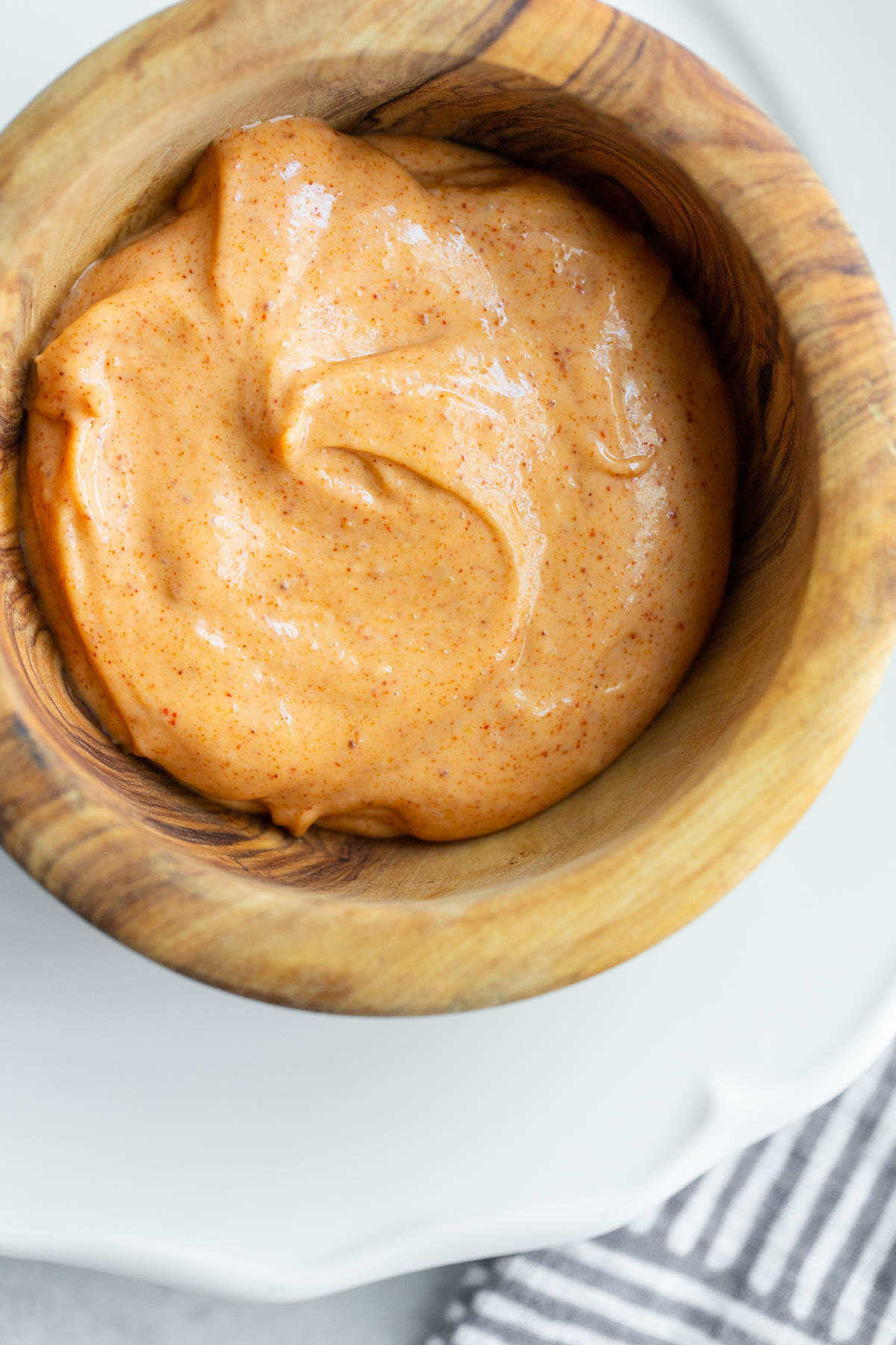 Peri peri mayo in a wooden bowl.