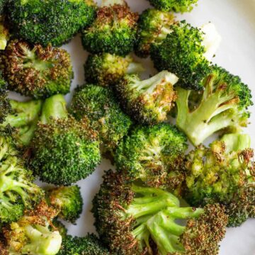 Air fried broccoli on a white plate
