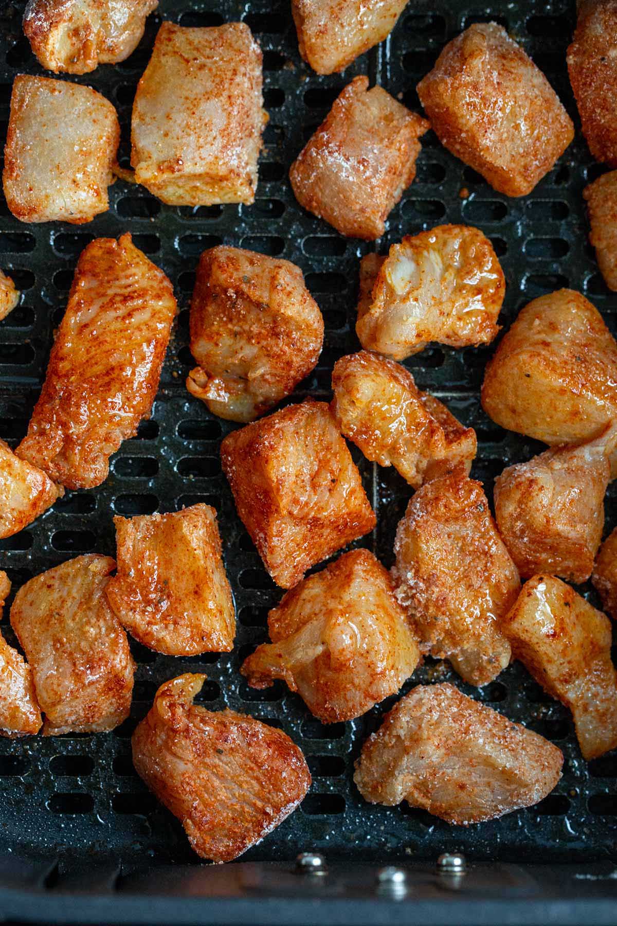 Uncooked chicken in air fryer basket