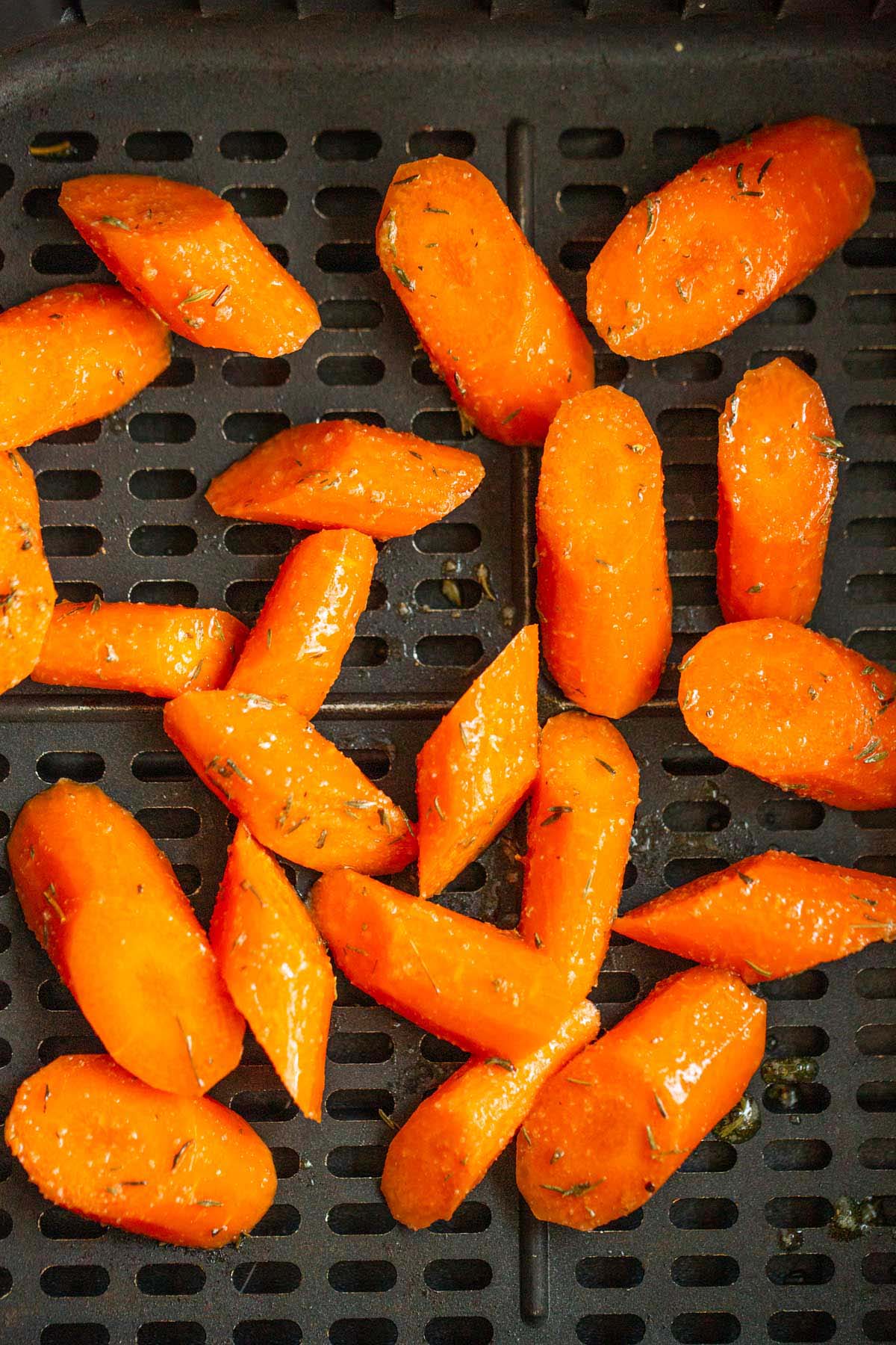 Uncooked carrots in air fryer basket