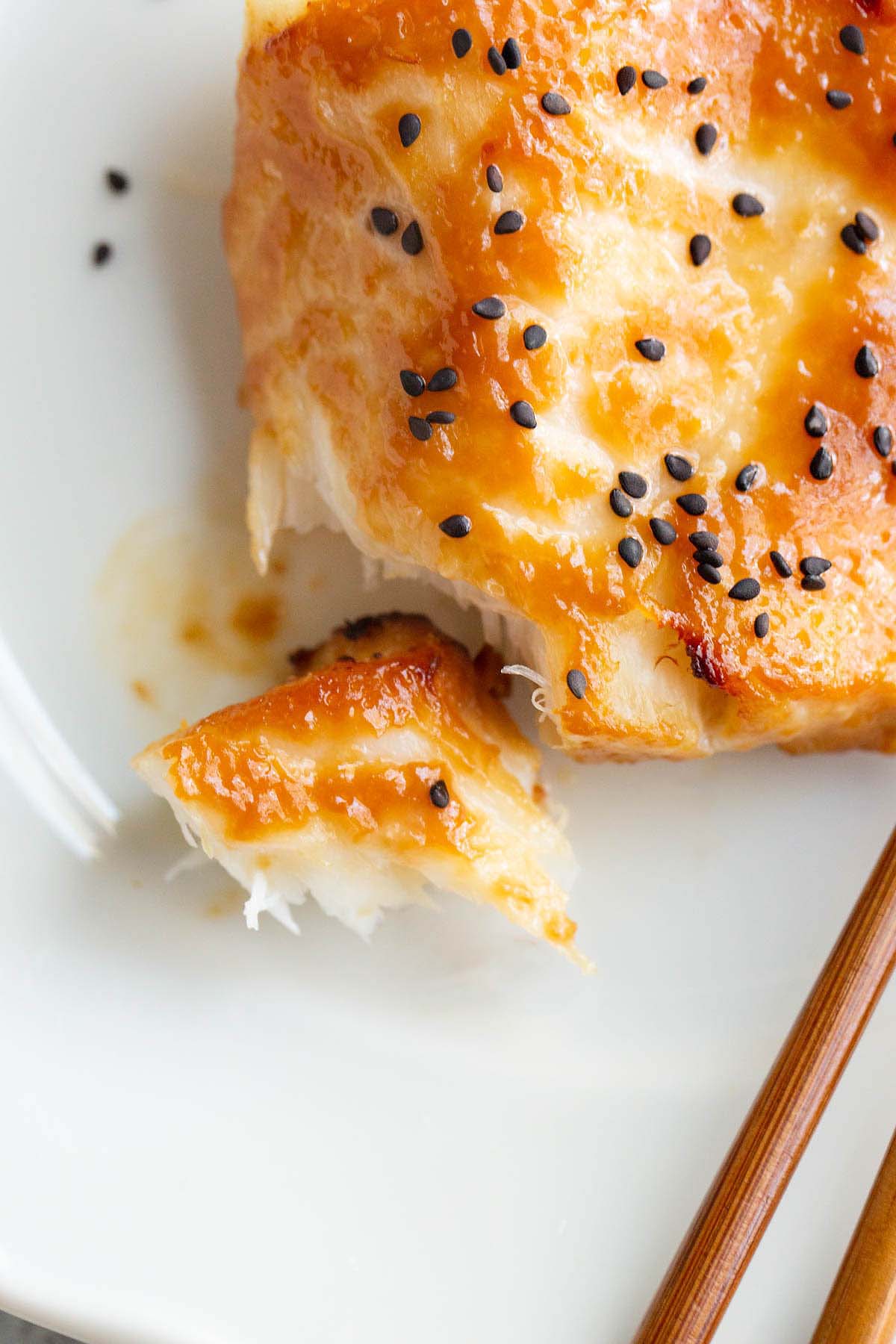 Air fryer miso cod up close with a piece flaked off