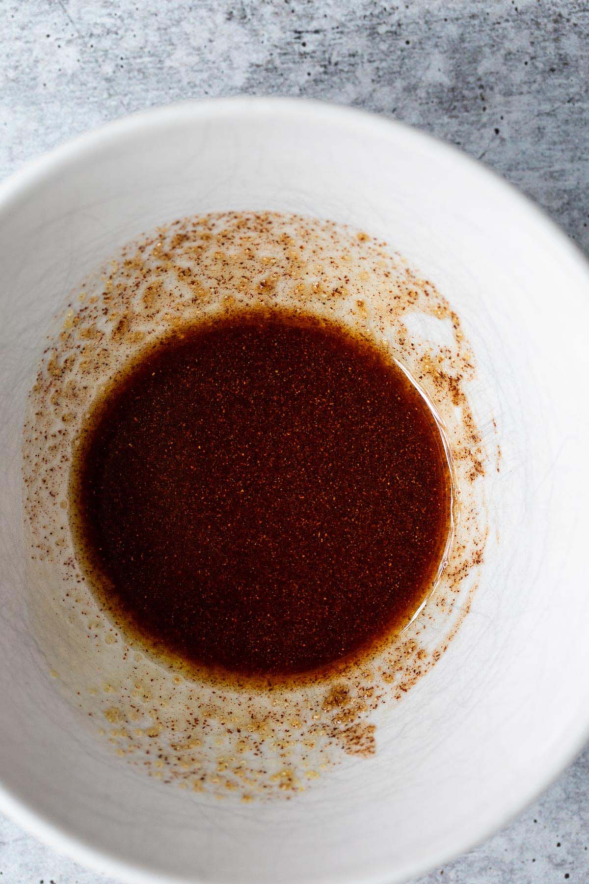 Cinnamon and olive oil in a white bowl