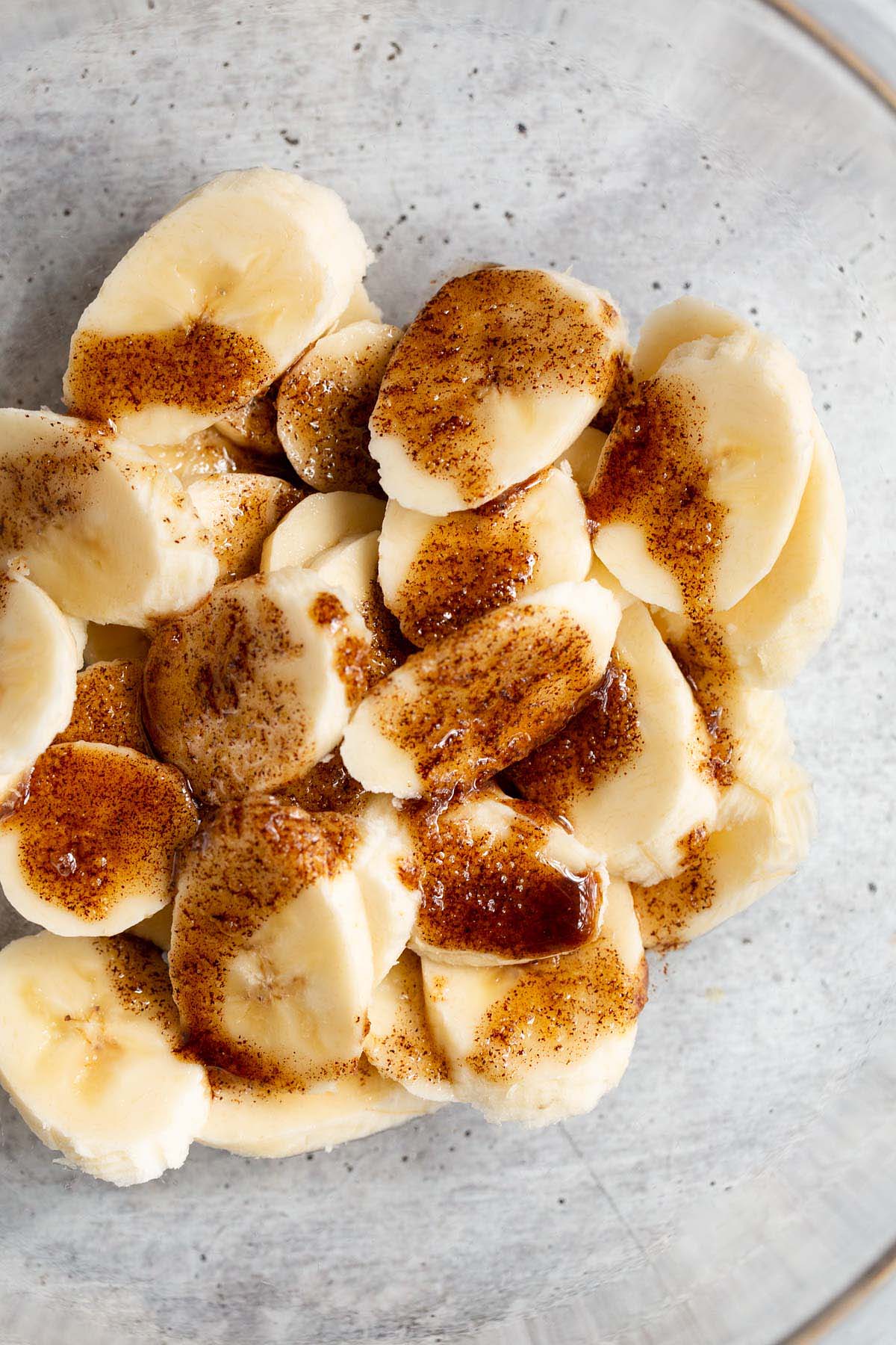 Cinnamon and oil poured onto banana slices