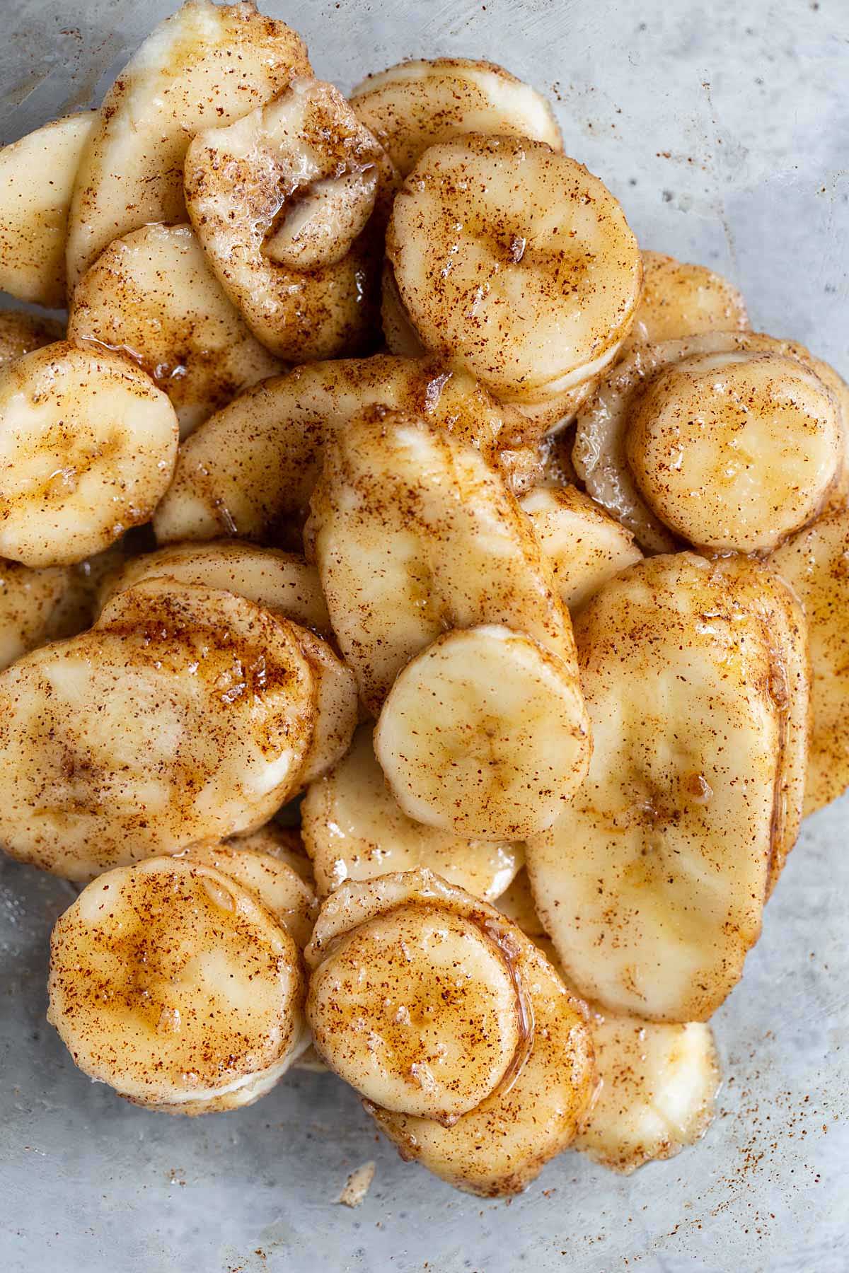 Banana slices tossed with cinnamon and oil