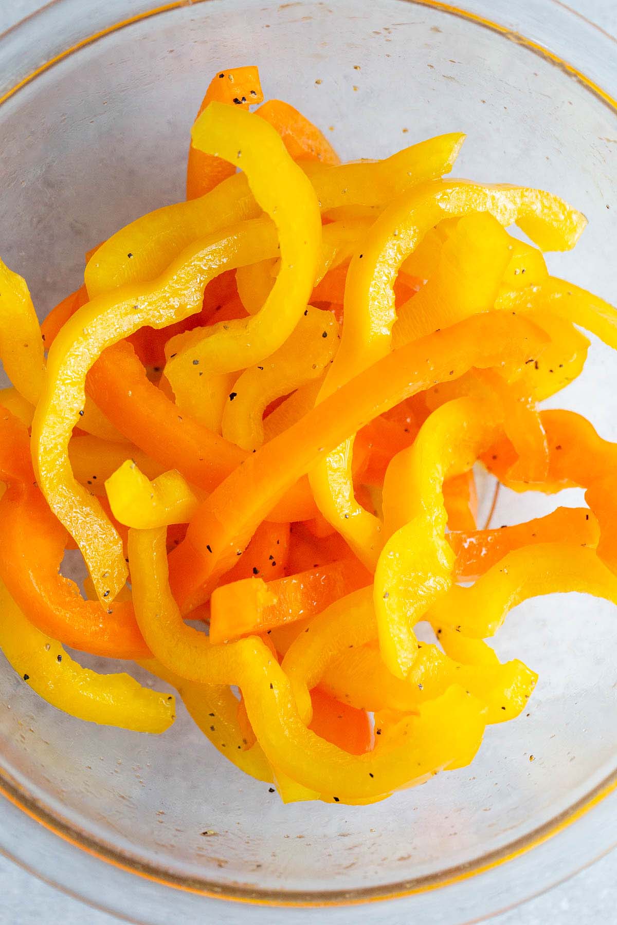 Sliced bell peppers tossed with oil and seasonings