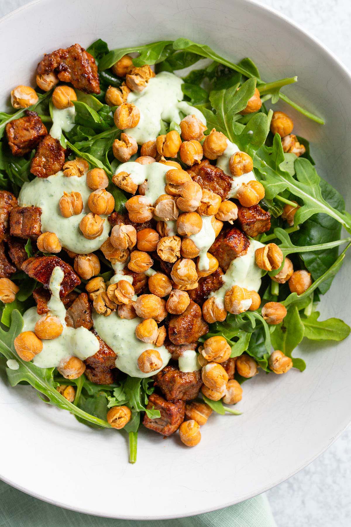 Air fried chickpeas on top of a salad