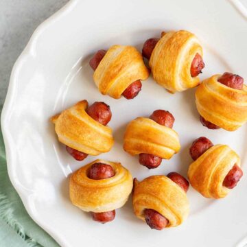 Air fryer pigs in a blanket on a white plate