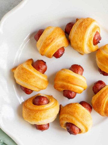 Air fryer pigs in a blanket on a white plate