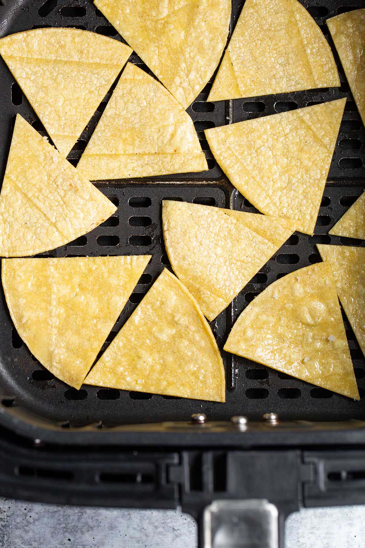 Uncooked tortilla chips in air fryer