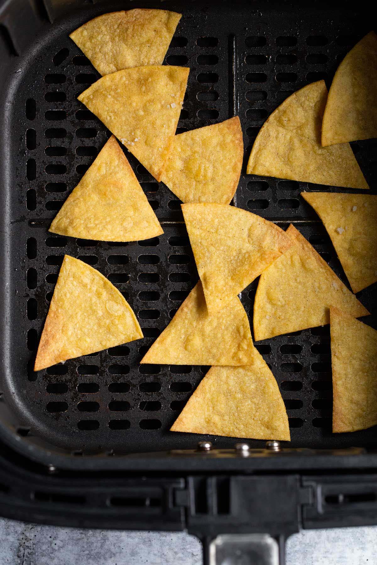 Tortilla chips in air fryer basket