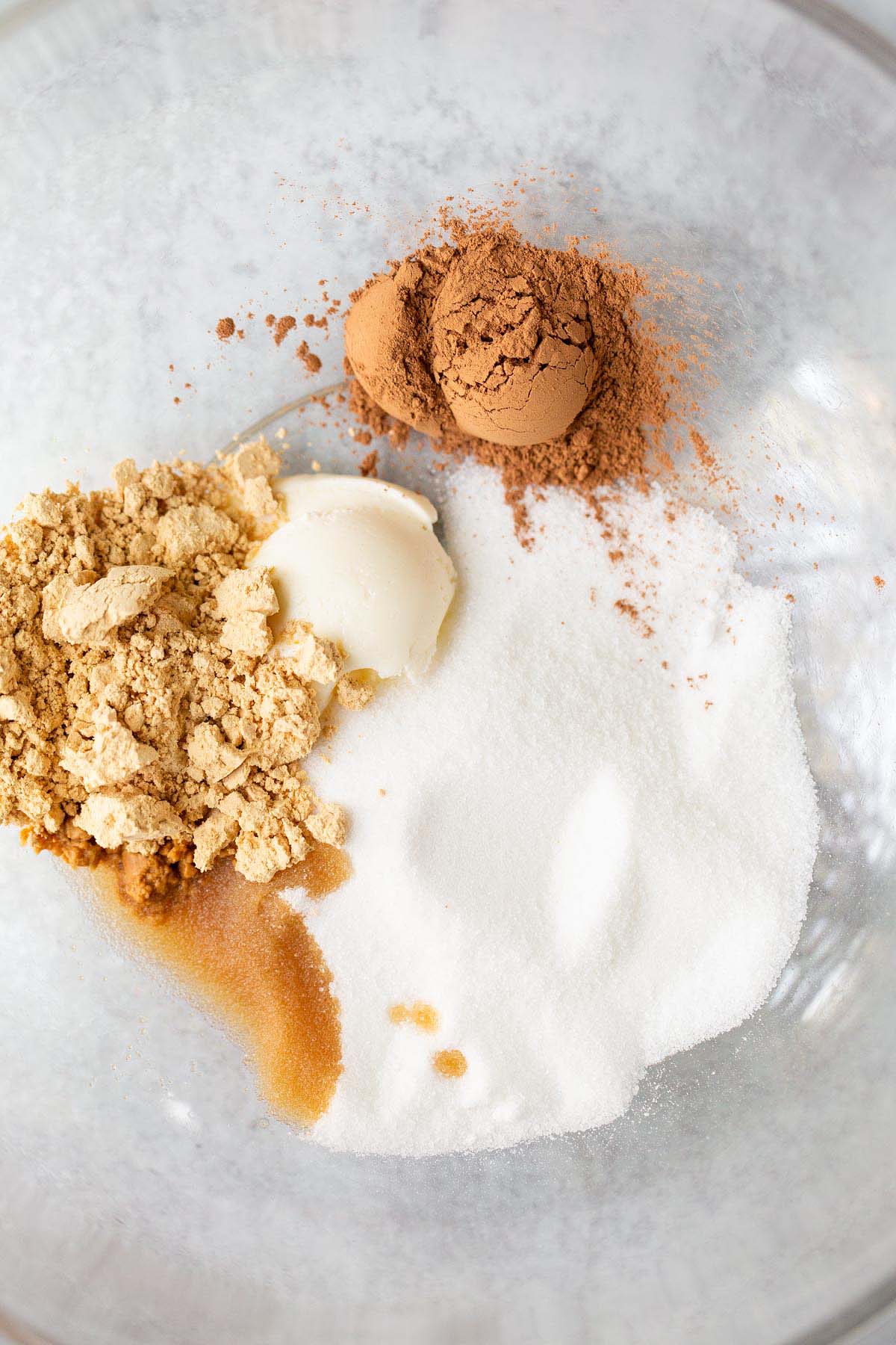 Cocoa powder, pb powder, vanilla, cream cheese, and sugar in a bowl.