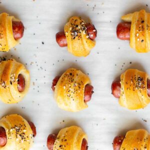 Everything bagel pigs in a blanket on a baking sheet