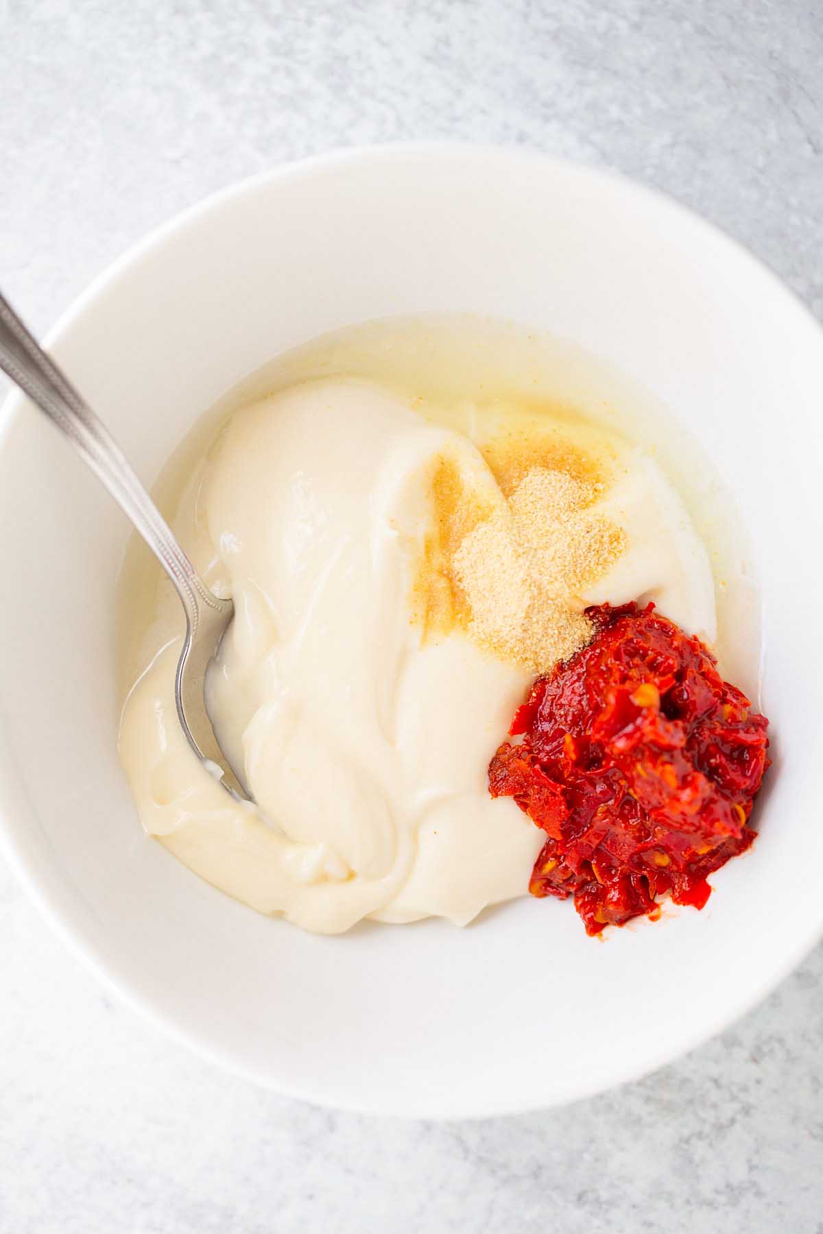 Ingredients for harissa mayo in a bowl