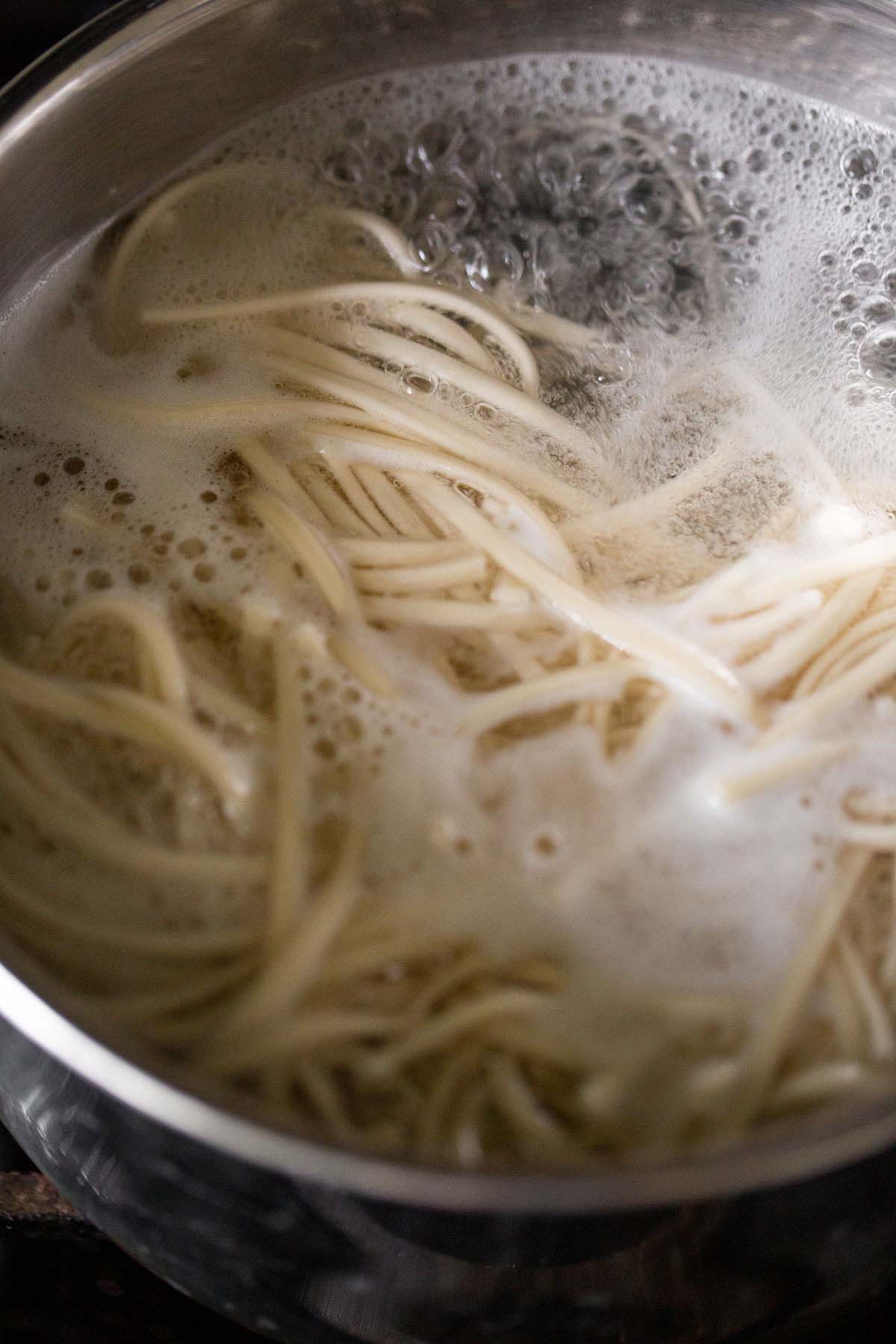 Cooking udon noodles in a pot