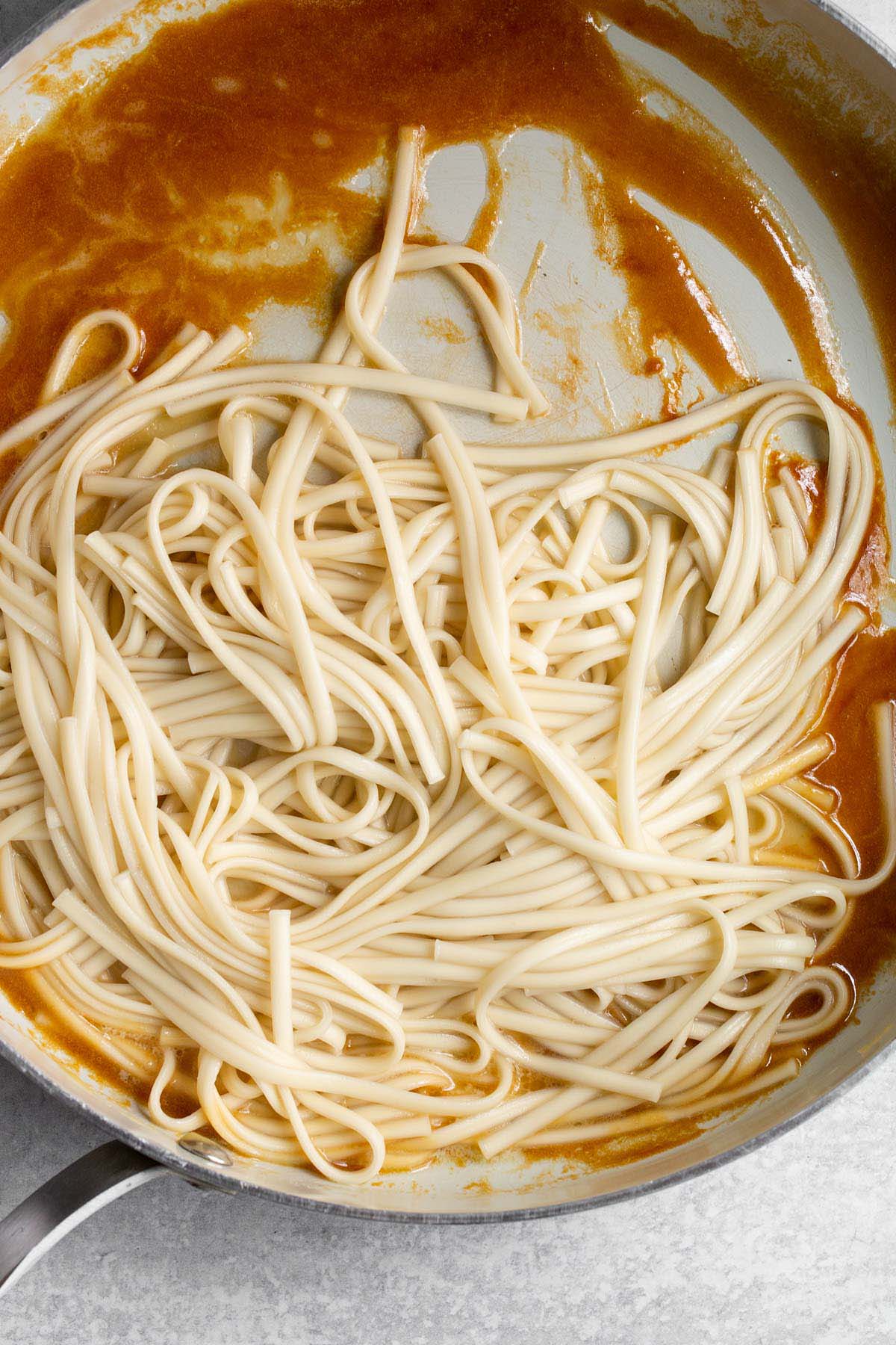 Mixing together noodles with miso butter sauce