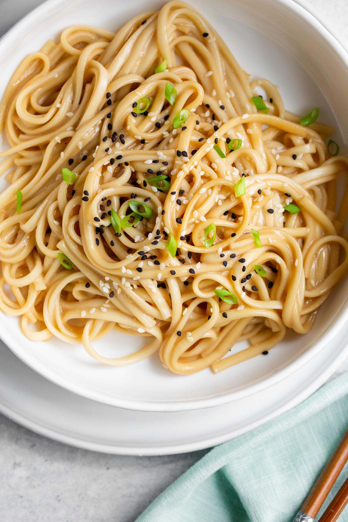 Miso butter noodles topped with sesame seeds and green onions