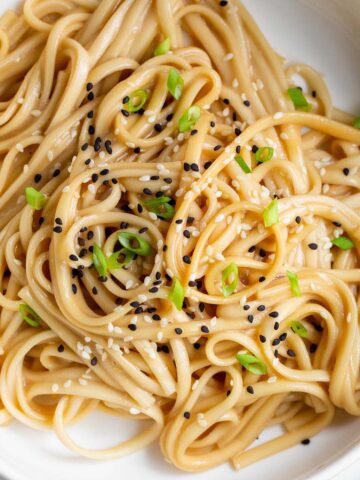 Miso butter noodles topped with sesame seeds and green onions