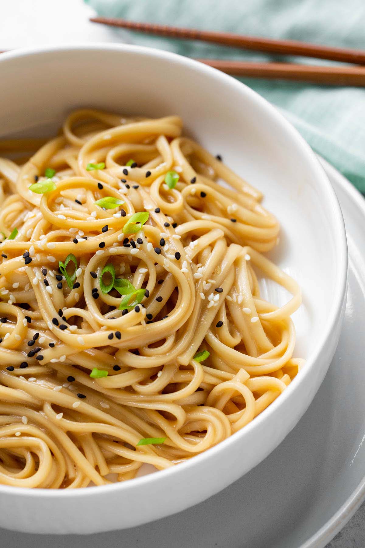 Miso butter noodles topped with sesame seeds and green onions