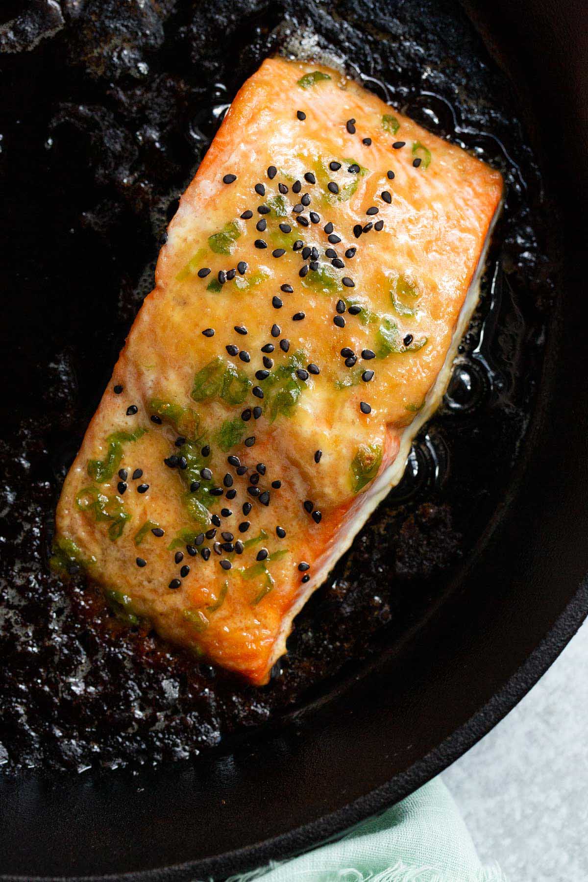 Cooked miso butter salmon in a cast iron skillet