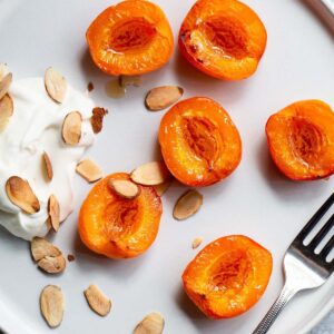 Air fryer apricots with whipped cream and sliced almonds.