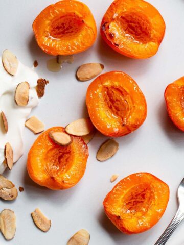 Air fryer apricots with whipped cream and sliced almonds.