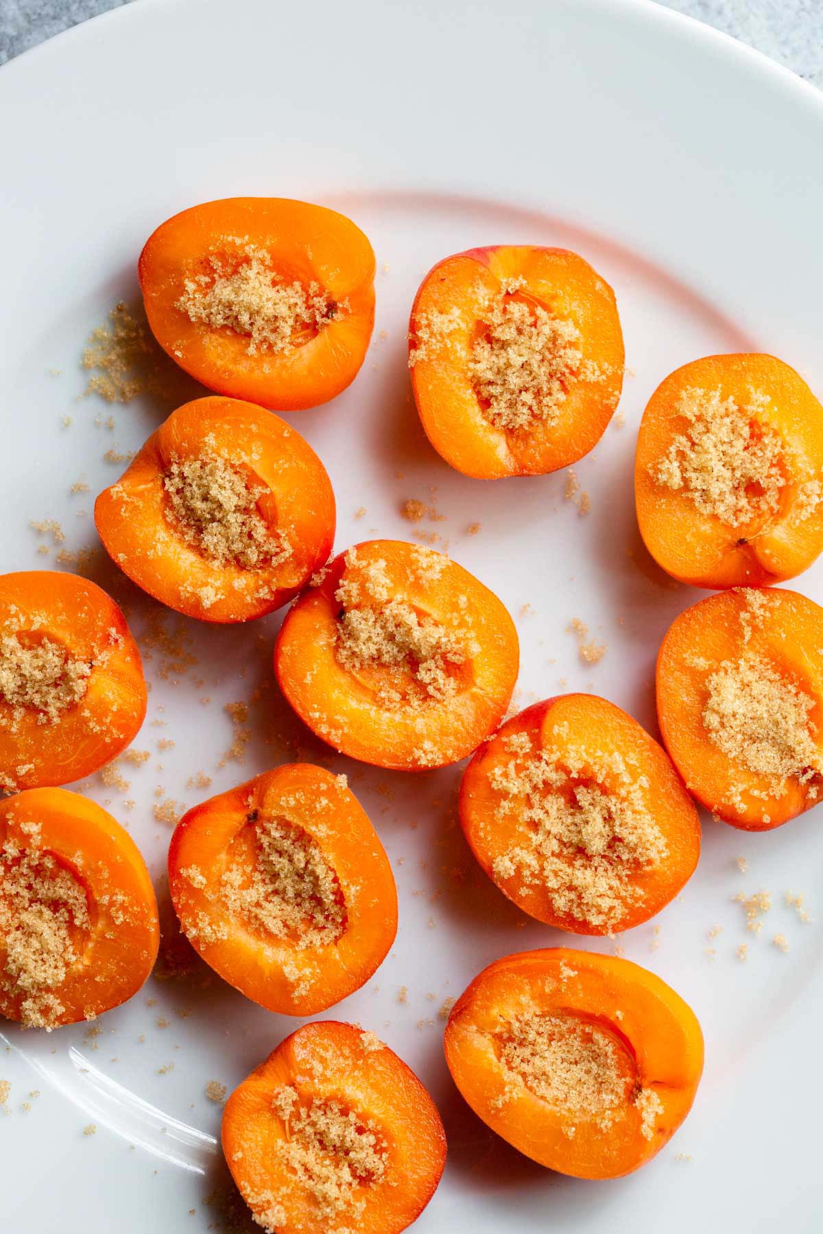 Apricots topped with brown sugar.