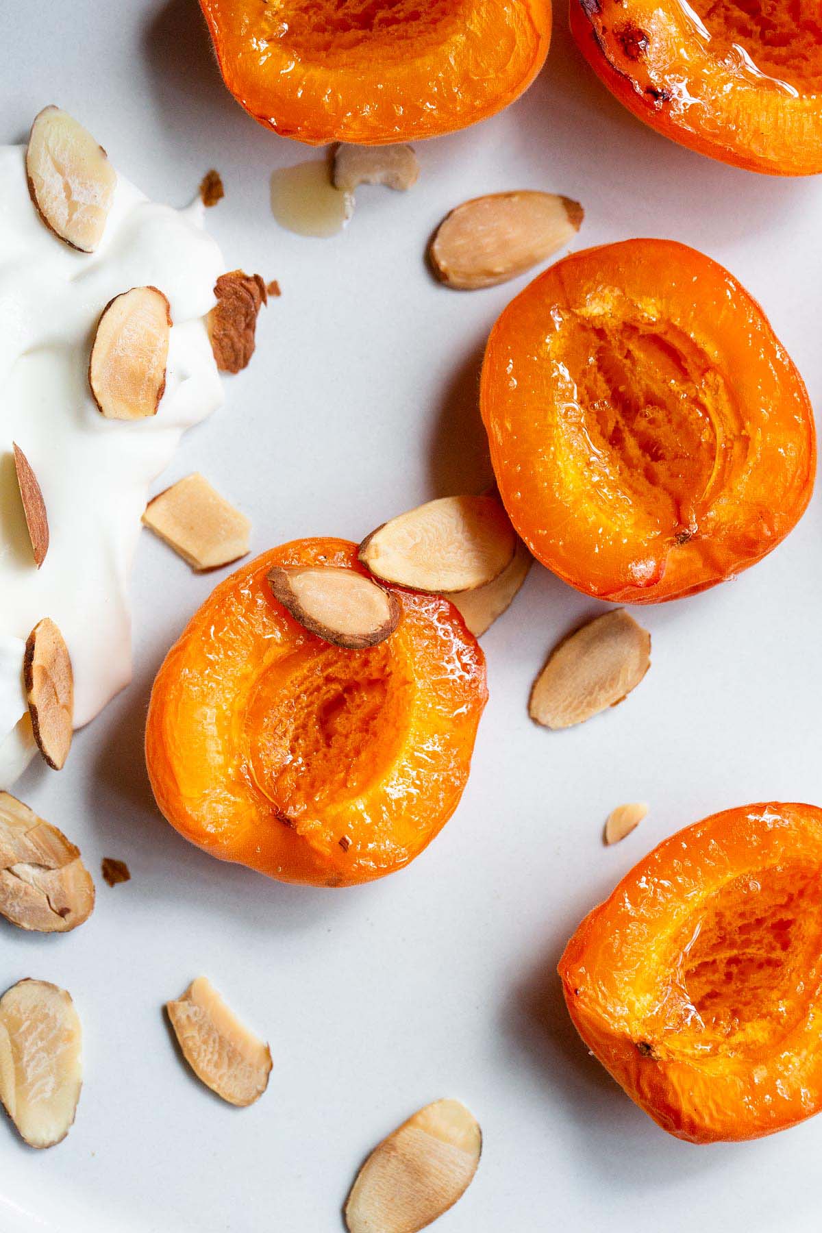 Air fryer apricots with whipped cream and sliced almonds.