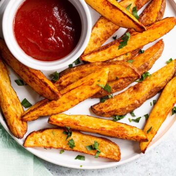 Air fryer potato wedges on a white plate