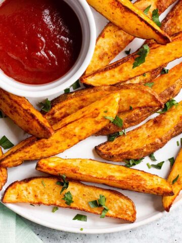 Air fryer potato wedges on a white plate